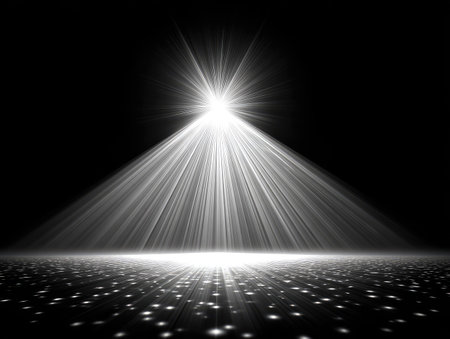 A stark visual presents a bright light emanating from above and illuminating a textured ground. The composition emphasizes the contrast between the bright light and the dark background. The image offers commercial uses for concepts such as spotlighting or a specific focus.の素材