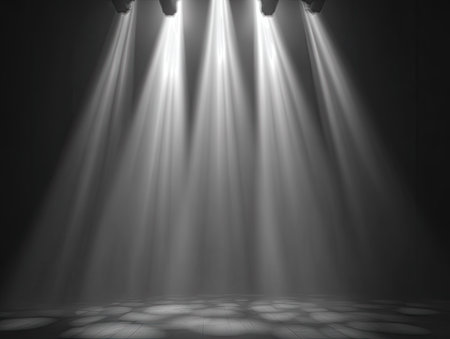 Three spotlights shine downwards creating dramatic light beams. The composition showcases a dark environment where the light creates strong highlights and shadows. This imagery could be used in various contexts, like theatrical presentations or for abstract visual concepts.の素材