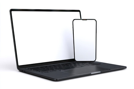 A laptop and smartphone are presented with empty screens against a clean white backdrop. The devices show a dark, sleek design with sharp lines. This image uses bright, even lighting, suggesting a studio setting. It may be suitable for advertisements, website mockups, or technology-focused editorial content.の素材