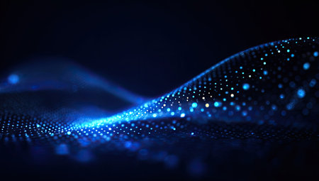 An abstract digital wave is displayed with a focus on glowing particles. The image shows shades of blue with a smooth, curved composition. The style appears modern with selective focus on bright, illuminated dots. This image could be used for various commercial and illustrative purposes.の素材