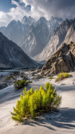 A high-angle view captures a vast mountain range under a dynamic cloudy sky. The composition presents steep rock formations with various textures and colors. The natural environment suggests a rugged terrain. Suitable for commercial projects and a range of editorial uses.の素材
