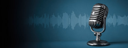 A classic microphone is presented against a blue backdrop, suggestive of audio recording. The image features a metallic finish, contrasting against the darker areas. The composition includes waveform lines, hinting at sound representation. Suitable for illustrating podcasting, music production, or other commercial projects requiring audio-visual elements.の素材