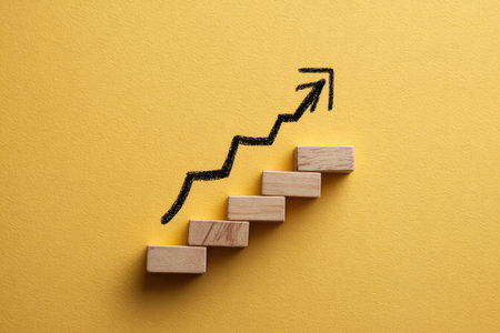 An upward-pointing arrow is drawn above a series of wooden blocks resembling steps. The composition is set against a plain yellow background. The style is minimalistic, with the black arrow contrasting against the natural wood and yellow hue. The visual suggests progress and could be suitable for business or educational materials.の素材