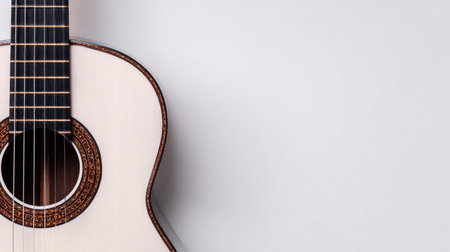 An acoustic guitar is presented against a solid white backdrop. The image highlights the instrument's form, showcasing its wooden textures and detailed craftsmanship. The composition employs strong lighting, creating visual interest. Suitable for design and commercial applications involving music or creative concepts.の素材