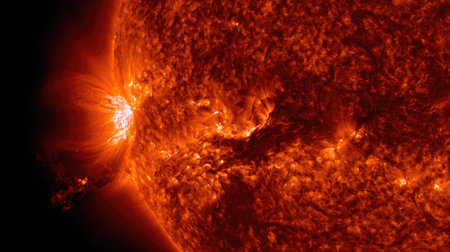 A detailed image presents a close-up view of the sun, highlighting solar flares with intense orange and yellow hues. The composition showcases dynamic textures and patterns across the solar surface. The lighting suggests a celestial or astronomical setting. This imagery is suitable for educational materials and scientific publications.の素材