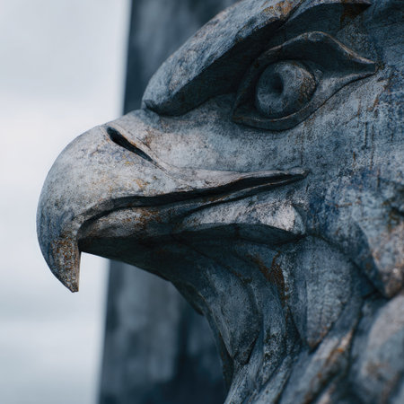 Close-up of an eagle head sculpture on a cloudy day.の素材