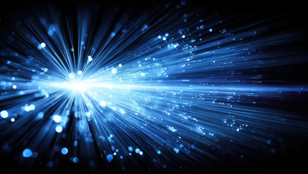 An artistic illustration presents a burst of bright blue light emitting from a central focus. The image features radiating beams with a dark background. It is likely created digitally, with potential use in technology, science, or conceptual designs. The style is modern, with potential commercial and editorial applications.の素材