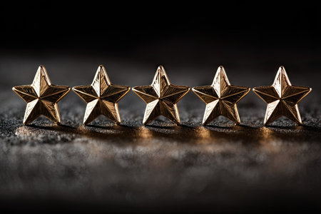 Five golden star figures are arranged in a horizontal row against a dark textured background. The stars feature metallic surfaces and are illuminated with directional lighting creating highlights and shadows. This composition may be used for concepts related to achievements, rankings or ratings suitable for various commercial projects.の素材
