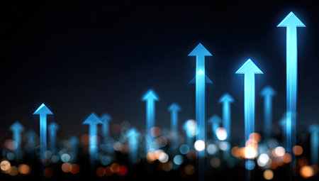 This image showcases a collection of illuminated blue arrows pointing upwards against a dark backdrop. The composition features blurred lights, suggesting a city environment. The visual style is modern, with a focus on abstract representation of progress and development suitable for various commercial uses.の素材