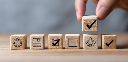 A hand places a wooden block with a checkmark, highlighting success. The image features several blocks with various icons, suggesting a process. Soft lighting and a neutral background add to the professional feel. Suitable for illustrating business, strategy, and project management themes for diverse media.の素材