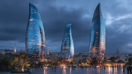 Three contemporary skyscrapers dominate the composition, showcasing a sleek, reflective design. The buildings feature curved facades in shades of blue and glass, set against a twilight sky with a palette of blues and grays. The scene depicts an urban setting and can be used for various commercial or editorial applications.の素材