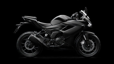A matte black motorcycle is presented against a stark black background. The image highlights the motorcycle's design, with details visible in the lighting. This image could be used for advertising, product showcases, or conceptual automotive presentations. The composition and style suit a modern aesthetic.の素材