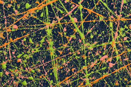This abstract artwork showcases a dynamic composition of splattered and dripping paint. The image features a dark background punctuated by streaks and dots of vivid orange and green. The style appears expressive and textured. Suitable for a range of commercial applications like website design or print materials.の素材