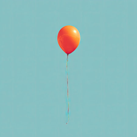 An orange balloon hovers in the air against a bright blue backdrop. The image showcases a smooth texture and a simple, minimalistic composition. The lighting appears even, suggesting an outdoor setting during the day. This image could be used for various commercial or editorial purposes.の素材