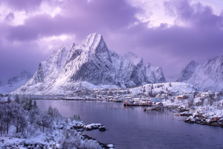 Dramatic landscape depicts snow-capped mountains reflected in a calm lake. The scene showcases a range of purple hues, with textures of snow and water contrasting with the jagged mountain peaks. The composition is balanced, illuminated by soft light, suggesting a remote environment suitable for scenic visuals or artistic projects.の素材
