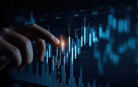 A close-up captures a hand interacting with a glowing digital chart displaying financial data. The image showcases blue hues, creating a modern, high-tech aesthetic. It highlights the use of data analysis in the context of business and finance. Suitable for illustrating concepts related to investment and market trends.の素材