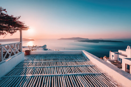 A scenic view of a coastal terrace overlooking the ocean under a vibrant sunset. The composition includes architectural elements of white buildings and a textured terrace. The scene is bathed in warm sunlight, creating a serene and inviting atmosphere. Suitable for travel or lifestyle content, it is ideal for commercial use.の素材