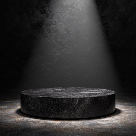 A dark, circular podium sits under a dramatic spotlight in this image. The stage has a textured appearance, and the background fades to black. The lighting creates a strong contrast and highlights the surface. Suitable for use in presentations, advertising, or showcasing products.の素材