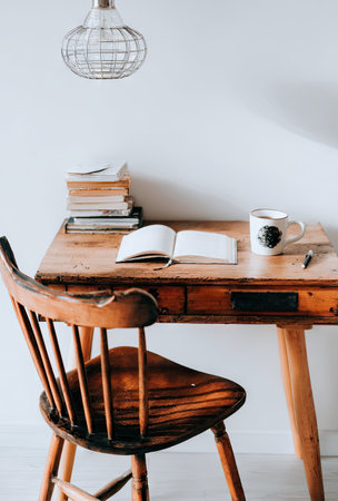 Wooden desk with book and cup of coffee - Vintage Light Filterの素材