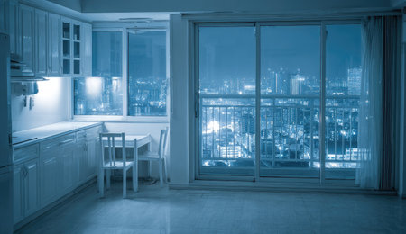 kitchen and dining room with city view at night in blue toneの素材