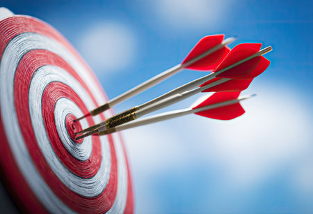 Darts arrows hitting the center of target, 3d illustration.の素材