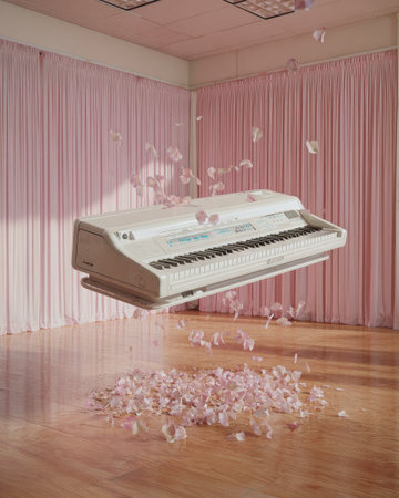 Digital composite of White piano with petals falling in the air against pink curtainの素材