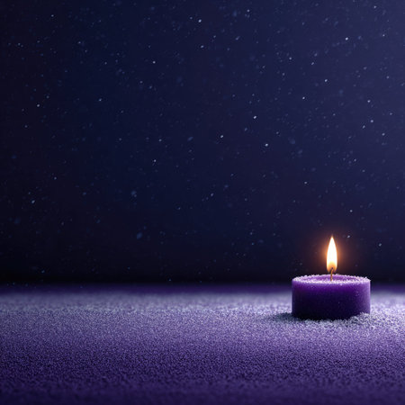 Candle on a purple background with snowflakes and copyspaceの素材