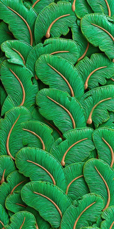 An overhead view reveals a pattern of numerous green leaves, each with a detailed vein structure. The leaves are rendered in a stylized manner, showcasing a vibrant green hue with contrasting light brown accents. This image is suitable for various commercial uses, including backgrounds or decorative elements.の素材