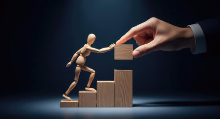 Businessman and wooden mannequin standing on top of growth graphの素材