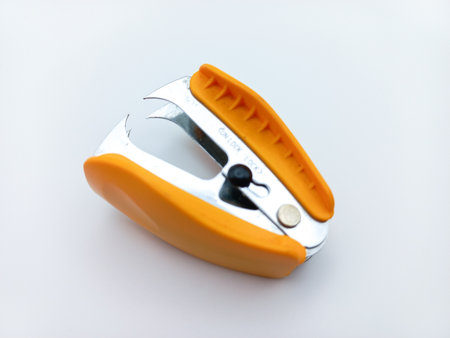 Orange Staple Remover Isolated On White Background. Tilted View From Aboveの写真素材