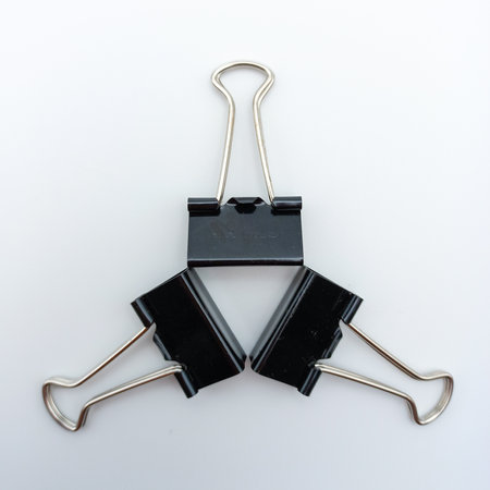 Three Binder Clips Arranged In Star Position Isolated On White Backgroundの写真素材