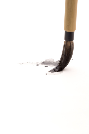 Chinese brushes draw on white papersの写真素材
