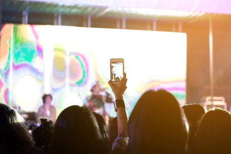 Out of focus crowd of Audience enjoying music in concert on stage