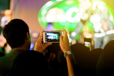 Out of focus crowd of Audience enjoying music in concert on stage