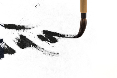 Chinese brushes draw on white papersの写真素材