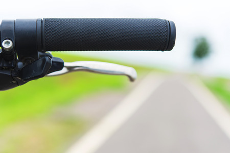 handlebar of a bicycle with bicycle lanes at parksの写真素材