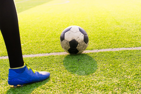 Soccer player ready to play at kick off the game in soccer field, background sunset, kick off, soccer gameの写真素材