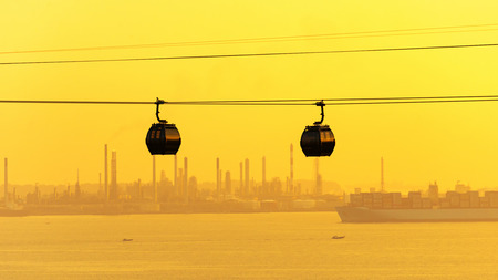Cable cars transportation to sentosa island with singapore port in backgroundsの写真素材