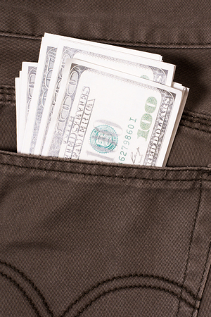 pocket pants stuffed with 100 Dollar billの写真素材