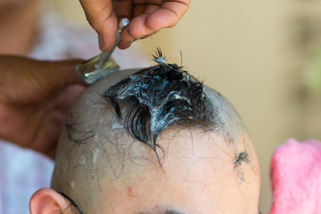 knife cutting hair at the ordination ceremony of a Buddhist monk in thailandの写真素材