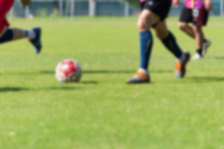 Blurred image of Soccer players in action playing football match