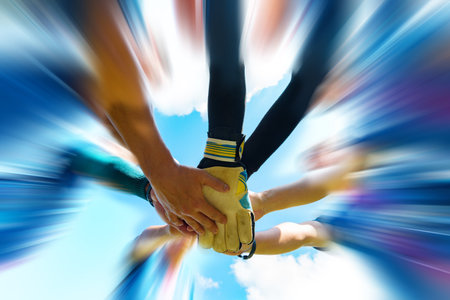 Blurred image of Soccer players hands together Join team energy for full power that makes winners