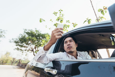 Using smartphone find GPS and internet for navigation transport by carの写真素材