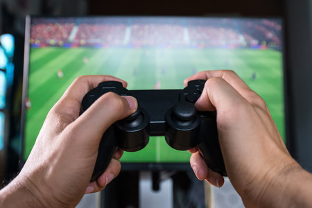 Hands Holding a Joystick Controller while playing a video games at home