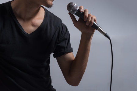 Man holding microphone, musician holding microphone, music device