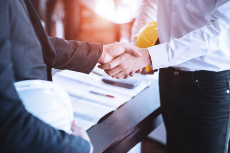 Engineers shaking hands agreement partners to work in conference Business negotiationsの写真素材