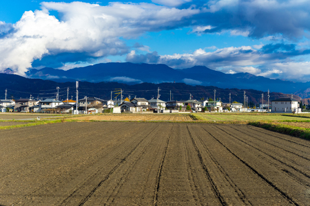 country village with field and mountain in autumn colour, Japanの写真素材