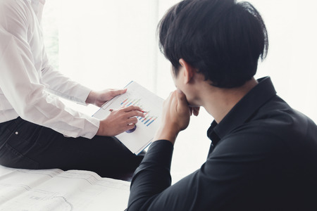 Business man coworkers present analyzing at the documents income charts and graphsの写真素材