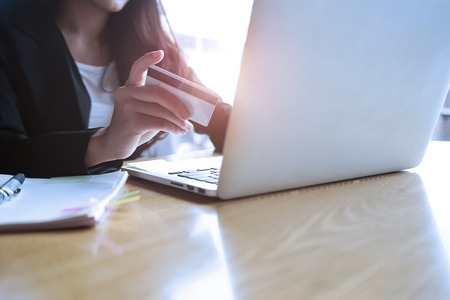 Asian businesswoman sitting at sofa working Laptop on table in coffee shopの写真素材