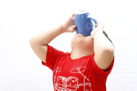 Little Boy Drinking from A Mugの写真素材